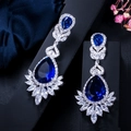 Close-up of royal blue teardrop earrings with AAA cubic zirconia on dark velvet - Blue