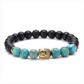 Detailed shot of black matte beads and blue emperor stone bracelet with golden Buddha head - Buddha Head - Antique Gold
