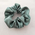 Detail of grey-green satin scrunchie showing silky texture and high elasticity - Grey Green
