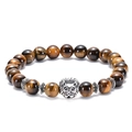 Macro shot of tiger eye stone beads featuring a silver lion head charm detail - Lion Head / Antique Silver