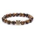Macro shot of tiger eye beaded bracelet featuring a vintage golden owl charm and spacers - Owl / Antique Gold