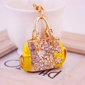 Golden handbag keychain with crystal rhinestones and yellow flower details - Yellow