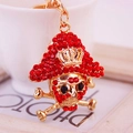 Skull keychain with red rhinestones and gold crown finish for stylish accessories - Red