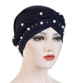 Close-up of navy blue turban hat with white pearls and braided detail on head model - Navy Blue
