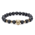Detailed shot of a black lava rock bead bracelet featuring a golden leopard head charm - Panther-Antique Gold