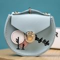 Close-up of light blue mini purse with tree embroidery and golden metal clasp closure - Light Blue