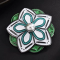 Elegant floral brooch with white and green enamel petals and a central pearl accent - Pentas