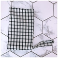 Detailed top view of a black and white checkered fabric pouch with a side handle strap - White With Black Grid