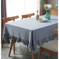 Close-up of gray-blue cotton tablecloth with ruffled edges on a wooden dining table - Gray Ruffle / 60*60cm