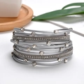Detailed macro view of multi-layer silver-gray bracelet with rhinestone accents and magnetic clasp - Silver