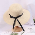 Elegant beige straw sun hat with black ribbon bow for women on a stylish stand - Adjustable / Beige (Black Bow)