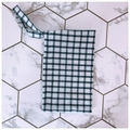Detail of a minimalist black and white checkered fabric pouch with wrist strap - White With Blue Grid