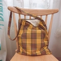 Classic yellow plaid canvas shoulder bag with zipper closure on a wooden chair - Yellow (Single Strap Crossbody)