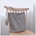 Detailed view of gingham canvas tote bag hanging on a wooden chair in soft daylight - White Base Black Grid - Single Strap (Crossbody/Shoulder)