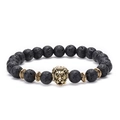 Macro shot of lava stone beads and detailed gold lion head charm on an elastic bracelet - Lion-Antique Gold