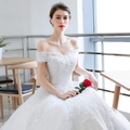 Elegant white off-shoulder bridal gown with intricate lace embroidery and puffy ball gown skirt - US 26W / Trailing