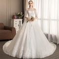 Elegant white lace wedding dress with off-shoulder neckline and intricate embroidery detail - US 26W / Floor-Length