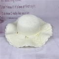 Elegant creamy white woven straw sun hat with wavy brim and pearl bow detail - M (56-58cm) / Creamy White