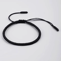 Detailed view of a handmade black braided knot bracelet with adjustable sliding closure - Black