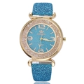 Detail of glittery blue dial and gold bezel with crystals on a ladies quartz watch - Light Blue