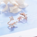 Elegant rose gold leaf stud earrings with marquise-cut cubic zirconia on blue background - Rose Gold