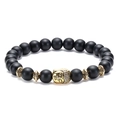 Detailed view of matte black 8mm beads and golden Buddha head on an elastic bracelet - Buddha Head - Antique Gold