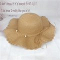 Straw sun hat with wide wavy brim and pearl decoration in natural khaki color - M (56-58cm) / Khaki