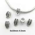 Detailed macro view of 6x10mm silver alloy pendant connector beads with striped texture - 8910-Silver Polka Dot