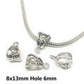 Macro view of 8x13mm vintage silver bail beads with embossed floral patterns and 6mm hole - 8759-Antique Silver Relief