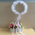 Detailed view of a white feather halo wreath featuring long elegant silk ribbons for costumes - White Wreath