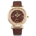 Macro detail of gold case with crystals and brown glitter dial on Rinnaoui quartz watch - Brown