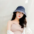 Close-up of a navy cotton bucket hat featuring blue and white plaid brim detailing - Navy Blue / M (56-58cm)