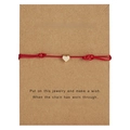Detail of red braided wish bracelet with gold heart charm on brown display card - Heart / Red