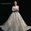 Robe de mariée luxueuse à épaules dénudées avec manches longues et dentelle scintillante - US 26W / Manches Longues Longueur Sol