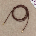 Dark brown braided PU leather waist rope with gold metal end caps on linen fabric - Camel