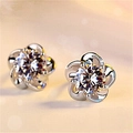 Macro shot of silver plum blossom stud earrings with a brilliant round cubic zirconia stone - Plum Blossom Silver (JED006)