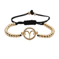 Macro shot of Aries zodiac charm with cubic zirconia on a black woven beaded bracelet - Aries