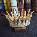 Close-up of vintage bridal crown with sparkling rhinestones and golden alloy detail - Gold