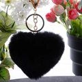 Close-up of black plush heart keychain with gold metal clasp and fluffy faux fur texture - Black