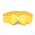 Detailed view of wide bright yellow elastic waist belt with large 3D bow decoration - Yellow