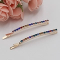Barrettes élégantes en métal doré avec strass colorés sur fond blanc décoré de fleurs - Couleurs Mixtes