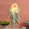 Close-up of mint green dream catcher with LED lights, soft feathers and wooden beads - With LED Light / Green