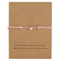 Pink woven wish bracelet with golden heart charm on a Make a Wish gift card display - Heart / Pink