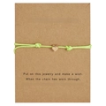 Detail of light green braided wish bracelet with a golden heart charm on a kraft card - Heart / Fluorescent Green