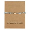 Close-up of light blue woven cord bracelet with gold heart charm on kraft card - Heart / Blue