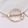 Detailed close-up of a gold metal hair clip with a minimalist star and circle design - Four Stars