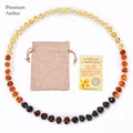 Natural Baltic amber baby necklace with linen pouch and certificate in gradient colors - Rainbow