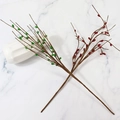 Artificial red and green berry branches on white marble background for Christmas decor - Red
