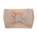 Detail showing soft skin-pink waffle texture fabric bow on elastic baby headband - Pre-tied Bow / Nude
