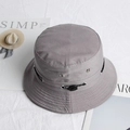 Close-up of grey bucket hat with adjustable drawcord, ventilation eyelets and brim stitching - Gray